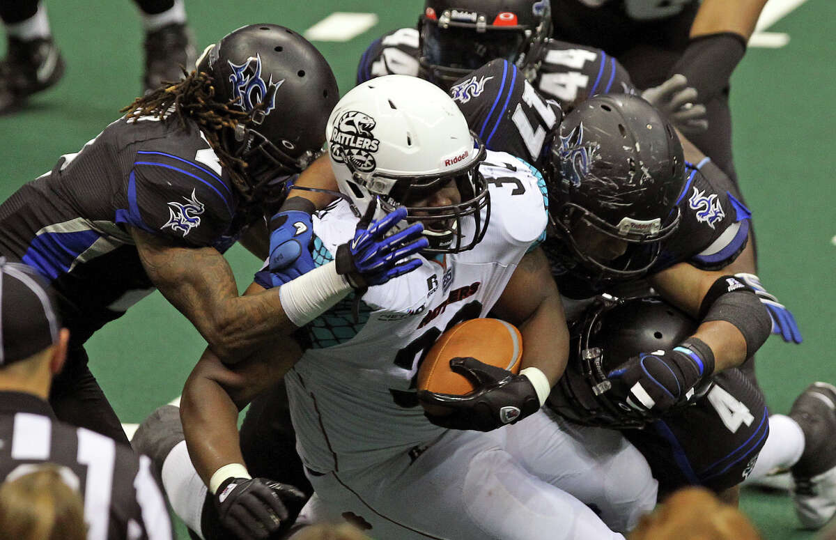 Rattlers fullback Odie Armstrong is swamped by Talon defenders as the Talons host the Arizona Rattlers at the Alamodome on July 13, 2012.