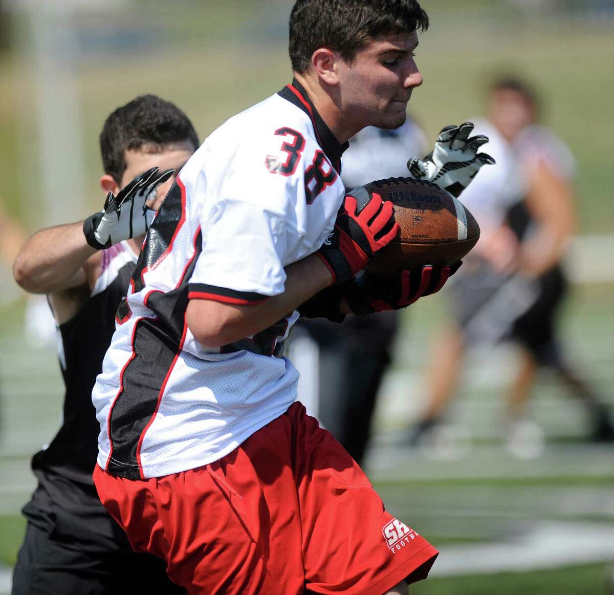 TJ Gallagher of Fairfield Warde High School participates in the 5th annual Connecticut Grip It and Rip It Passing Camp at New Canaan High School on Saturday, July 14, 2012.