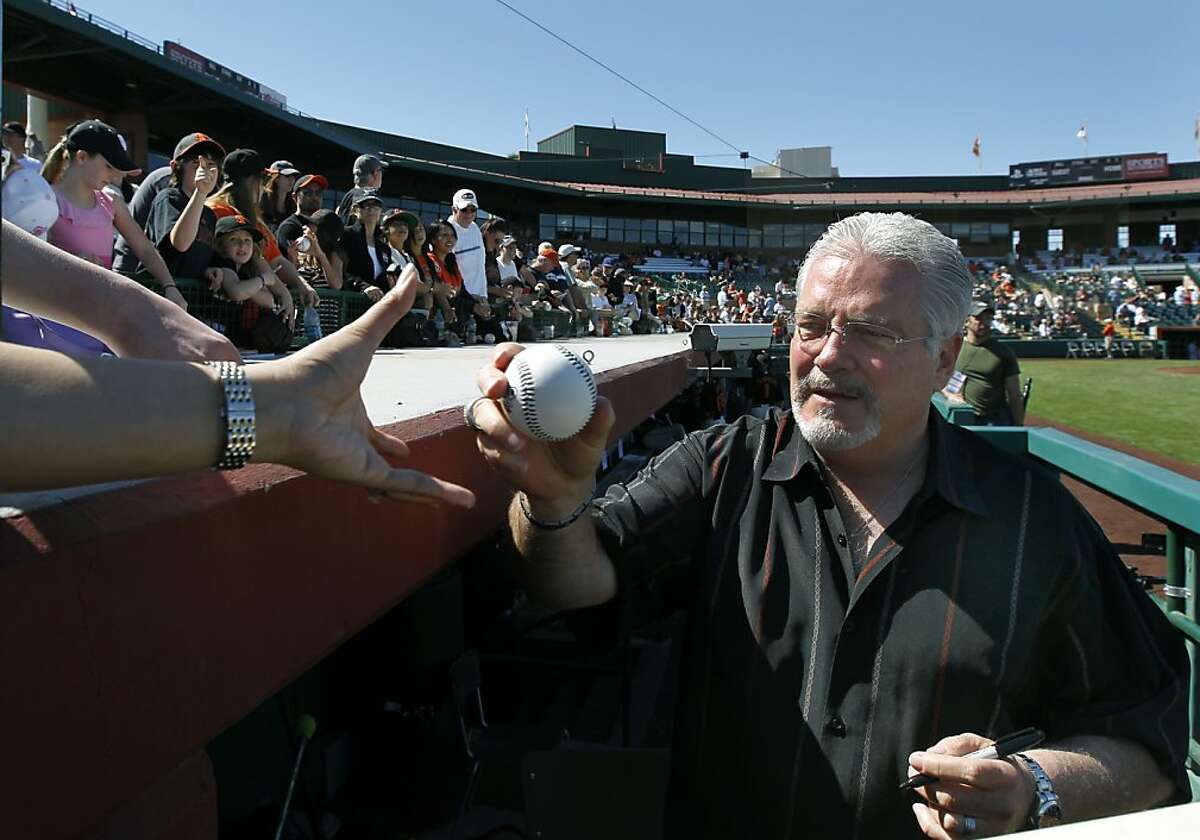 General Manager Brian Sabean autographs baseballs for fans before the San Francisco Giants Cactus League spring training opener against the Arizona Diamondbacks in Scottsdale, Ariz. on Saturday, March 3, 2012.