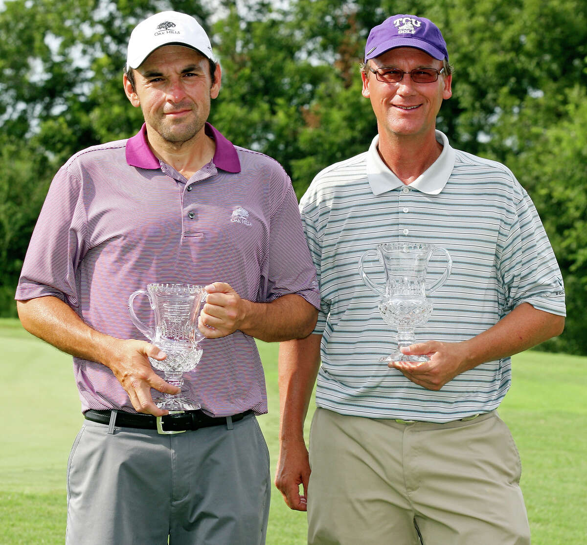 Ed Sanchez (left) and Bobby Baugh pose for photos with their trophies after the Greater San Antonio Match Play Championship finals Sunday July 15, 2012 at Willow Springs Golf Course. Sanchez won the men's division and Baugh won the senior men's division.