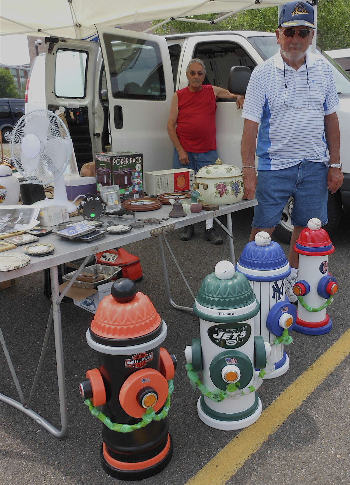 Westporter Bob Duffy sells handmade wooden sports-themed fire hydrants at Fairfield Ludlowe High's Sunday flea market.