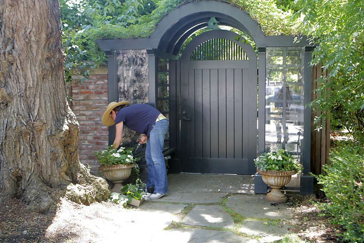A gardener who did not want to be identified works on the exterior of Billionaire Mark Zuckerberg's home in Palo Alto, Calif. on Monday, July 16, 2012.