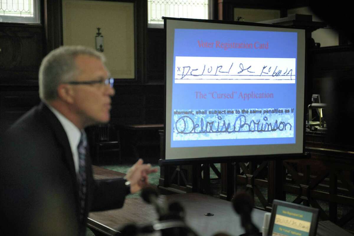 Special Prosecutor Trey Smith shows an image of the signature of a voter, top, and the alleged forged signature that was on a ballot at the Rensselaer County Courthouse on Tuesday, July 17, 2012 in Troy, NY. Lawyers gave their closing arguments in the trial of Michael Loporto on allegations of ballot fraud in the 2009 Working Families Party primary in Troy. (Paul Buckowski / Times Union)