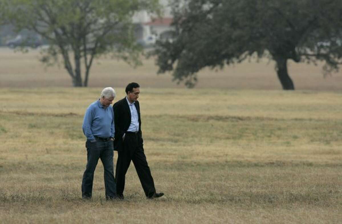 Former President Bill Clinton and Henry Cisneros, former mayor of San Antonio and former Secretary of Housing and Urban Development under President Clinton, walk on the grounds of Palo Alto College after speaking at a rally in support of Ciro Rodriguez, Democratic candidate Texas' 23rd Congressional District, in San Antonio on Sunday, December 10, 2006. (LISA KRANTZ / SAN ANTONIO EXPRESS-NEWS)