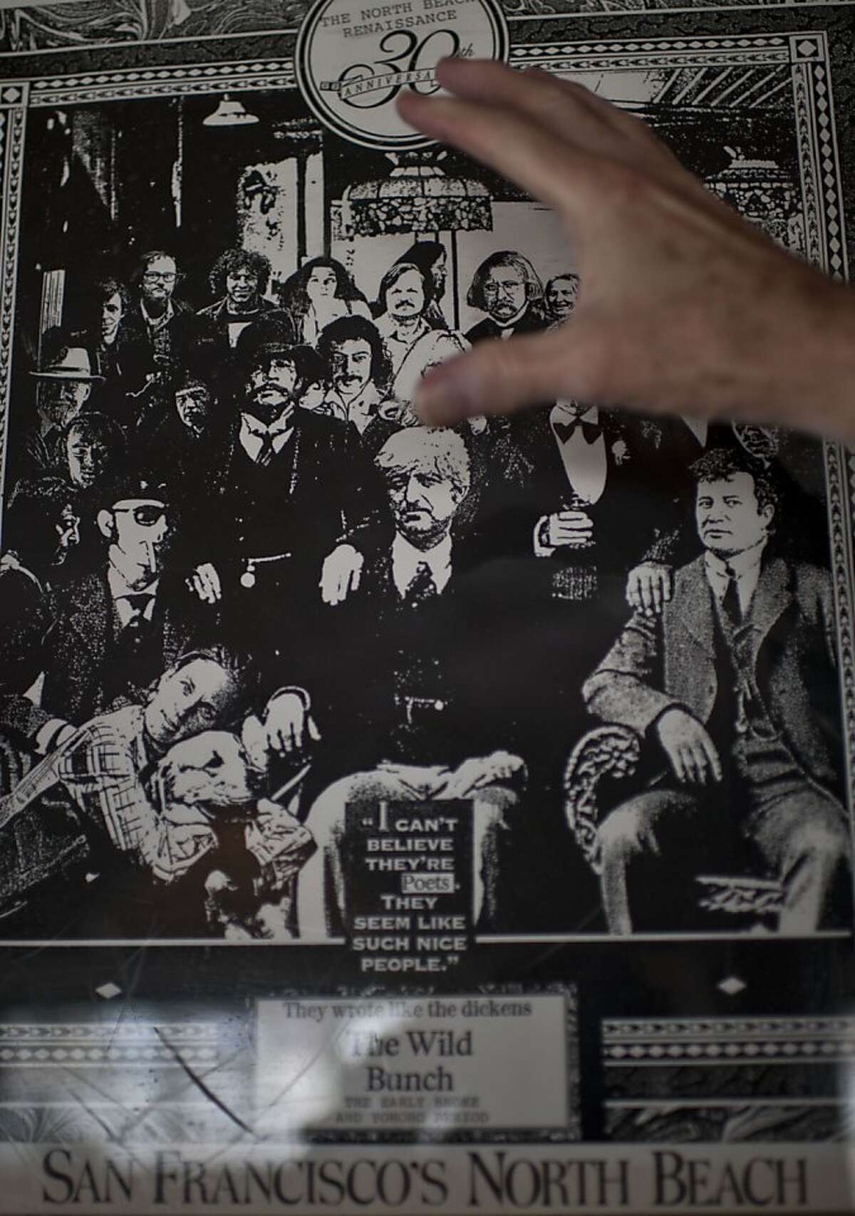 AD Winans shows himself in a smaller version of a 1970's poster of poets gathered at Vesuvio bar, in the North Beach neighborhood of San Francisco, Calif on Friday, July 13, 2012.