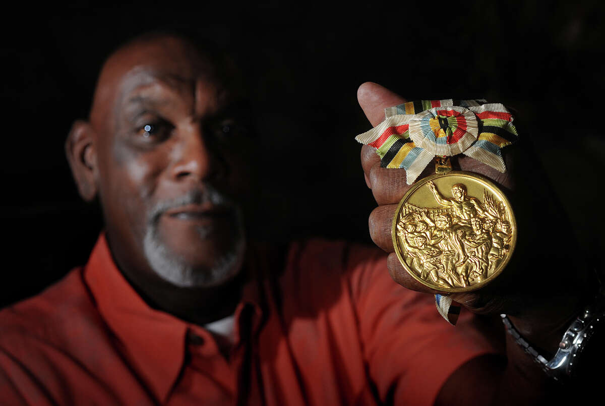 Luke Jackson of Beaumont shows the gold medal he won during the 1964 Olympics in Tokyo. Jackson played basketball for The U.S. and is now retired as the director of Parks and Recreation for the City of Beaumont. Photo taken Tuesday, July 17, 2012 Guiseppe Barranco/The Enterprise