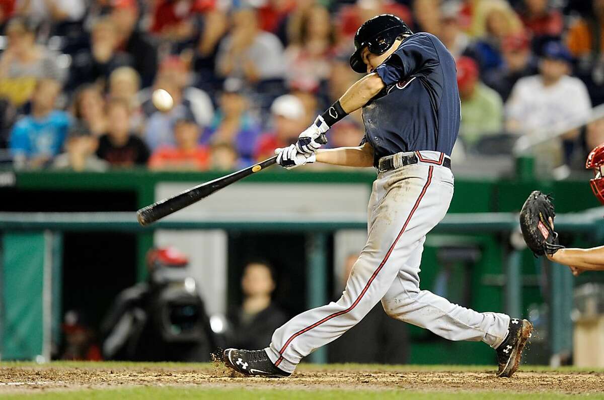 WASHINGTON, DC - JULY 20: Paul Janish #4 of the Atlanta Braves hits a single to drive in the game winning run in the eleventh inning against the Washington Nationals at Nationals Park on July 20, 2012 in Washington, DC. Atlanta won the game 11-10. (Photo by Greg Fiume/Getty Images)