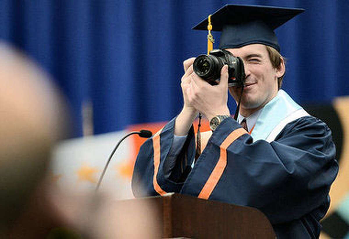 In this file photo from The Post-Standard, Syracuse University Scholar Stephen Barton of the Colleges of Arts and Sciences takes a photo as he addresses the Syracuse University 158th Commencement. Photo credit: Stephen D. Cannerelli/ The Post-Standard
