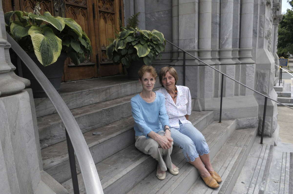 Lynn Kopka, left, president of Washington Park Association, and Hannelore Wilfert, a member of the Washington Park capital committee, sit on the front steps of St. Mary's Church on the corner of Third and Washington on Monday, July 18, 2011 in Troy. (Paul Buckowski / Times Union)