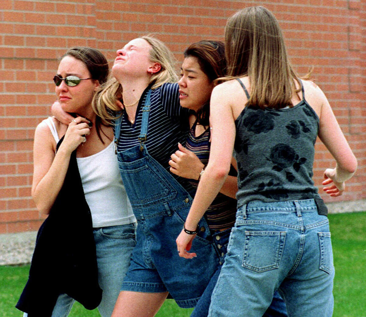 FILE - In this April 20, 1999, file photo unidentified young women head to a library near Columbine High School where students and faculty members were evacuated after two gunmen went on a shooting rampage in the school in the southwest Denver suburb of Littleton, Colo. Gun control advocates sputter at their own impotence. The National Rifle Association is politically ascendant. And Barack Obamas White House pledges to safeguard the Second Amendment in its first official response to the deaths of at least 12 innocents in a mass shooting at a new Batman movie screening in suburban Denver. Once, every highly publicized outbreak of gun violence produced strong calls from Democrats and a few Republicans for tougher controls on firearms. Now those pleas are muted, a political paradox thats grown more pronounced in an era scarred by Columbine, Virginia Tech, the wounding of a congresswoman and now the shootings in a suburban movie theater where carnage is expected on-screen only. (AP Photo/Kevin Higley, File)