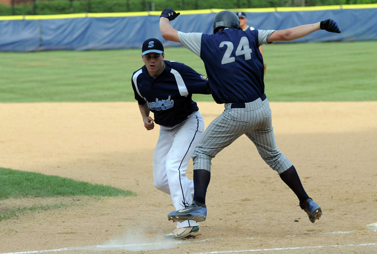 Stamford's Kevin Epp tags Newington's Bryant Marauder out as Stamford hosts Newington in a Senior American Legion state tournament game at Cubeta Stadium in Stamford, Conn., July 23, 2012.