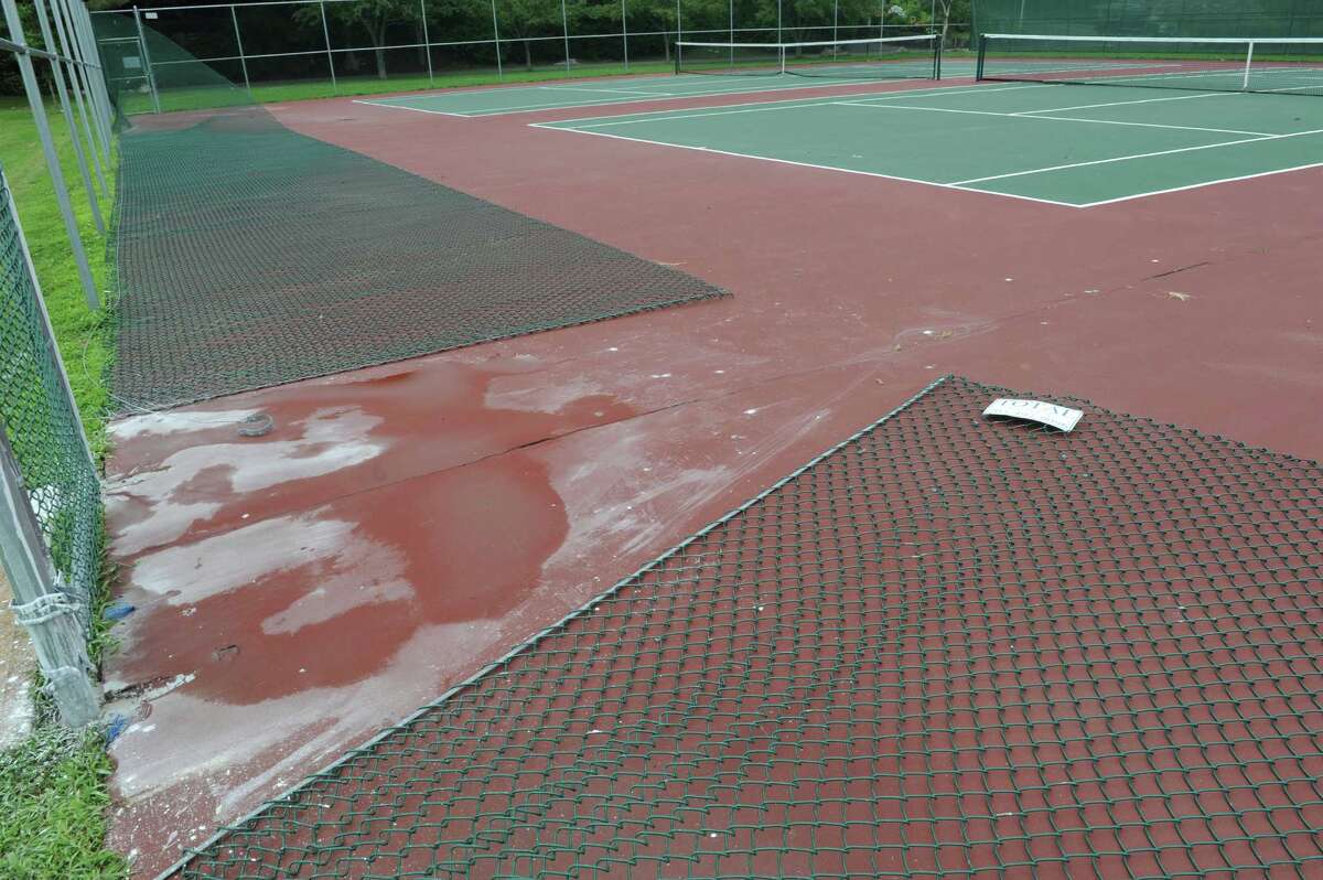 Tennis court fence being repaired
