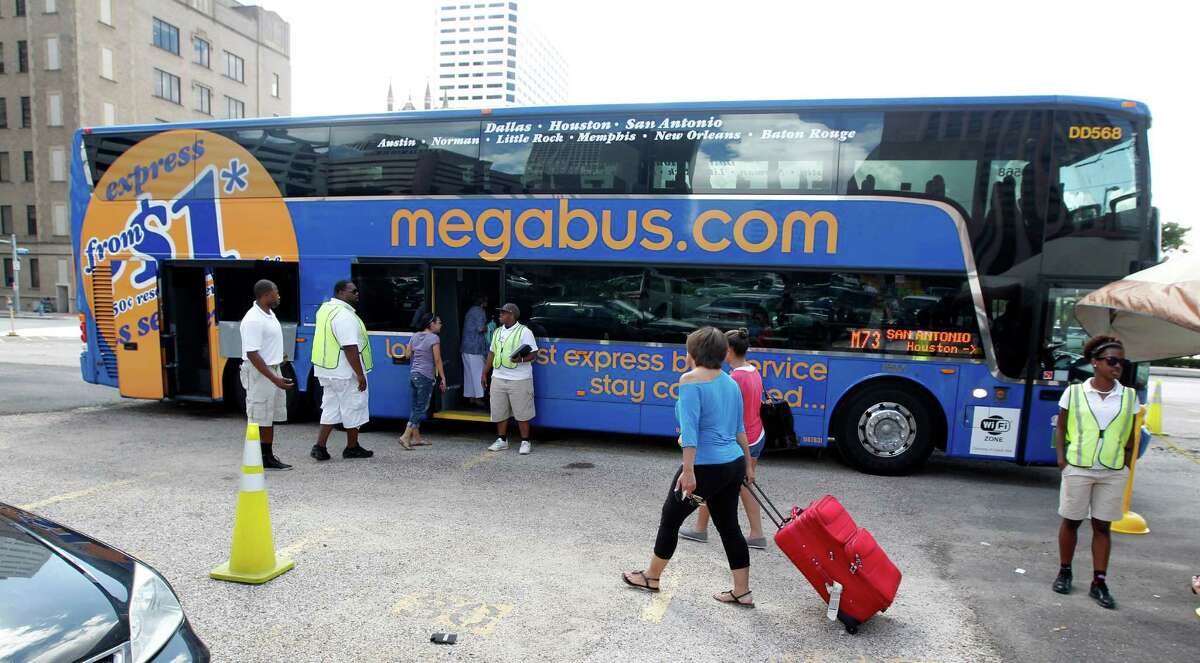 Passengers board a Megabus at Travis and Clay streets, Megabus is a low-cost inter-city bus company that has recently started service in Texas Tuesday, July 17, 2012, in Houston. ( James Nielsen / Chronicle )