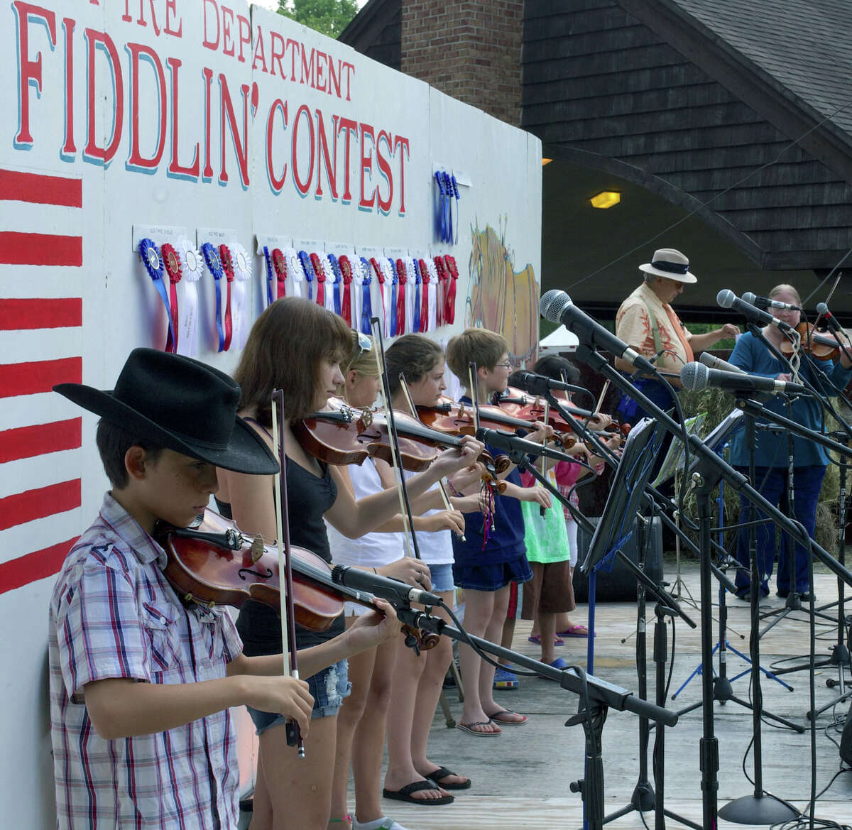 Students of Linda Embser, right, of Manchester perform during the Roxbury Volunteer Fire Department's annual Pickin' and Fiddlin' Contest at Hurlburt Community Park in Roxbury. July 10, 2012