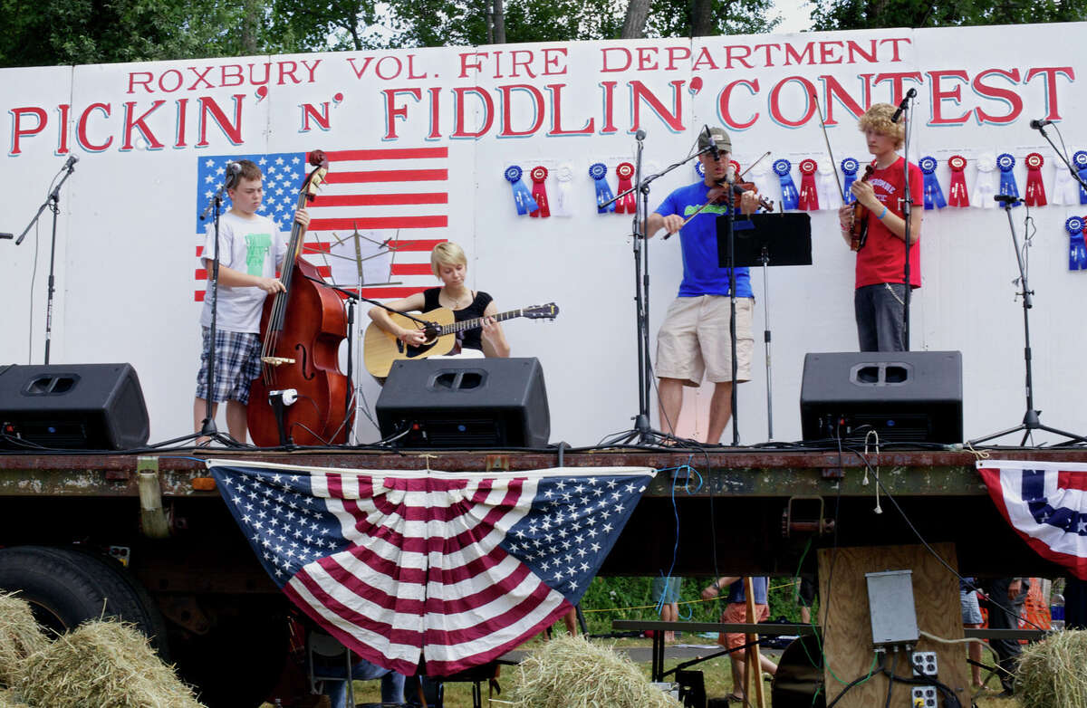 Representatives of the After School Arts Program in Washington perform during the Roxbury Volunteer Fire Department's annual Pickin' and Fiddlin' Contest at Hurlburt Community Park in Roxbury. From left to right are Jahred Martin, 13, of Washington on base, Sydney Alworth, 17, of Roxburyon guitar, Shepaug Valley middle/high school teacher Friso Hermans on fiddle and Max Lepelley, 17, of Sherman. , July 10, 2012