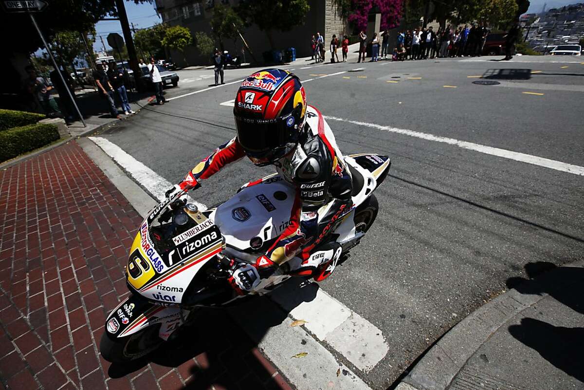 MotoGP racer Stefan Bradl takes his race bike down Lombard Street.