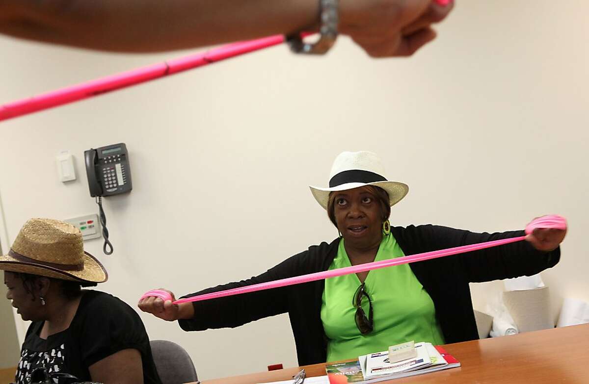 Henrietta Petty, 70 years old, from Oakland being instructed on how to use a dyna band to strengthen her arms and legs at the Fall Prevention Clinic at Highland hospital in Oakland, Calif., on Monday, July 23, 2012. State hospital data show nearly 73,000 people over age 60 were admitted to a hospital as a result of a fall within the past year.