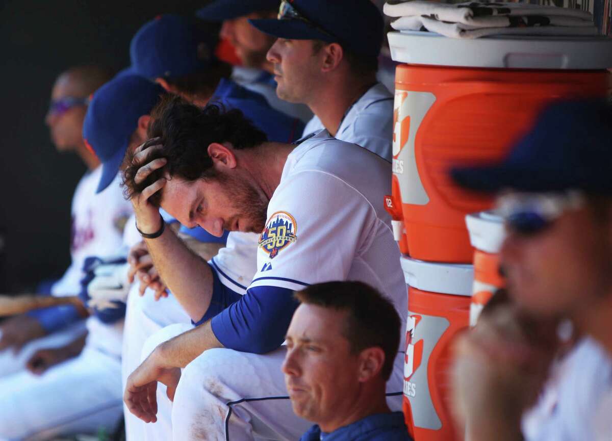 New York Mets' Ike Davis sits in the dugout during the ninth inning of a baseball game against the Washington Nationals, Wednesday, July 25, 2012, at Citi Field in New York. The Nationals beat the Mets 5-2 to sweep the series. (AP Photo/Seth Wenig).