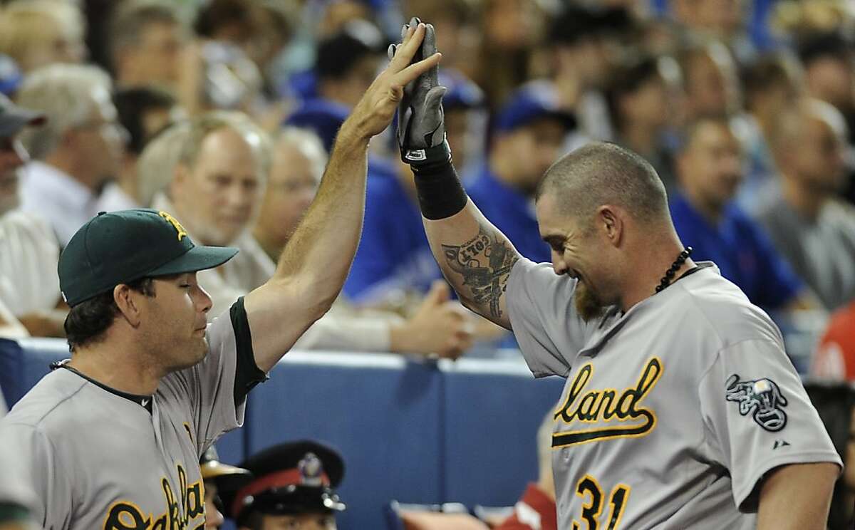 'Spiderman' Reddick helps A's toast Jays