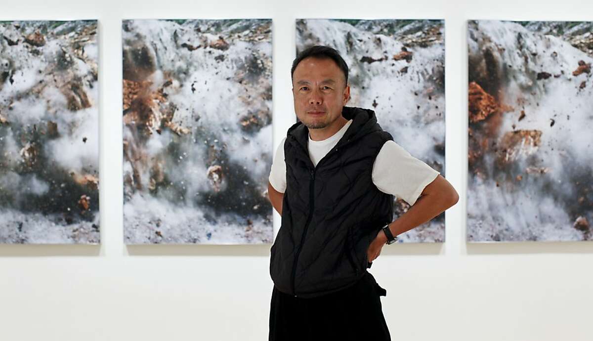 Photographer Naoya Hatakeyama, seen on Tuesday, July 24, 2012 in San Francisco, Calif. in front of images from his Blast series, will have his first show in the U.S. at SFMOMA.