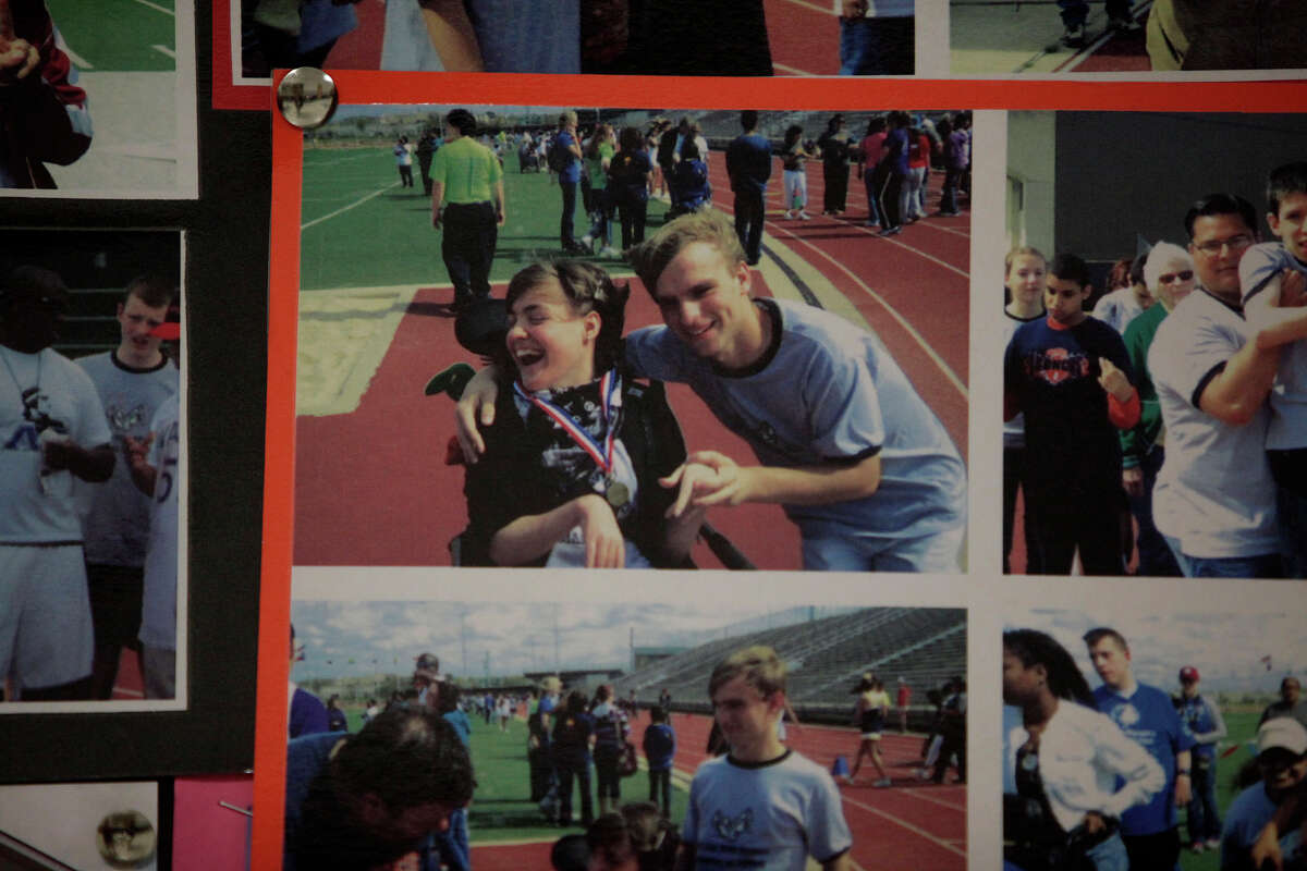 Photos of Kassie Sanchez and Adrian Pressey at a Special Olympics track and field event hang in a display cabinet in a hallway at Clark High School on Thursday, May 10, 2012.