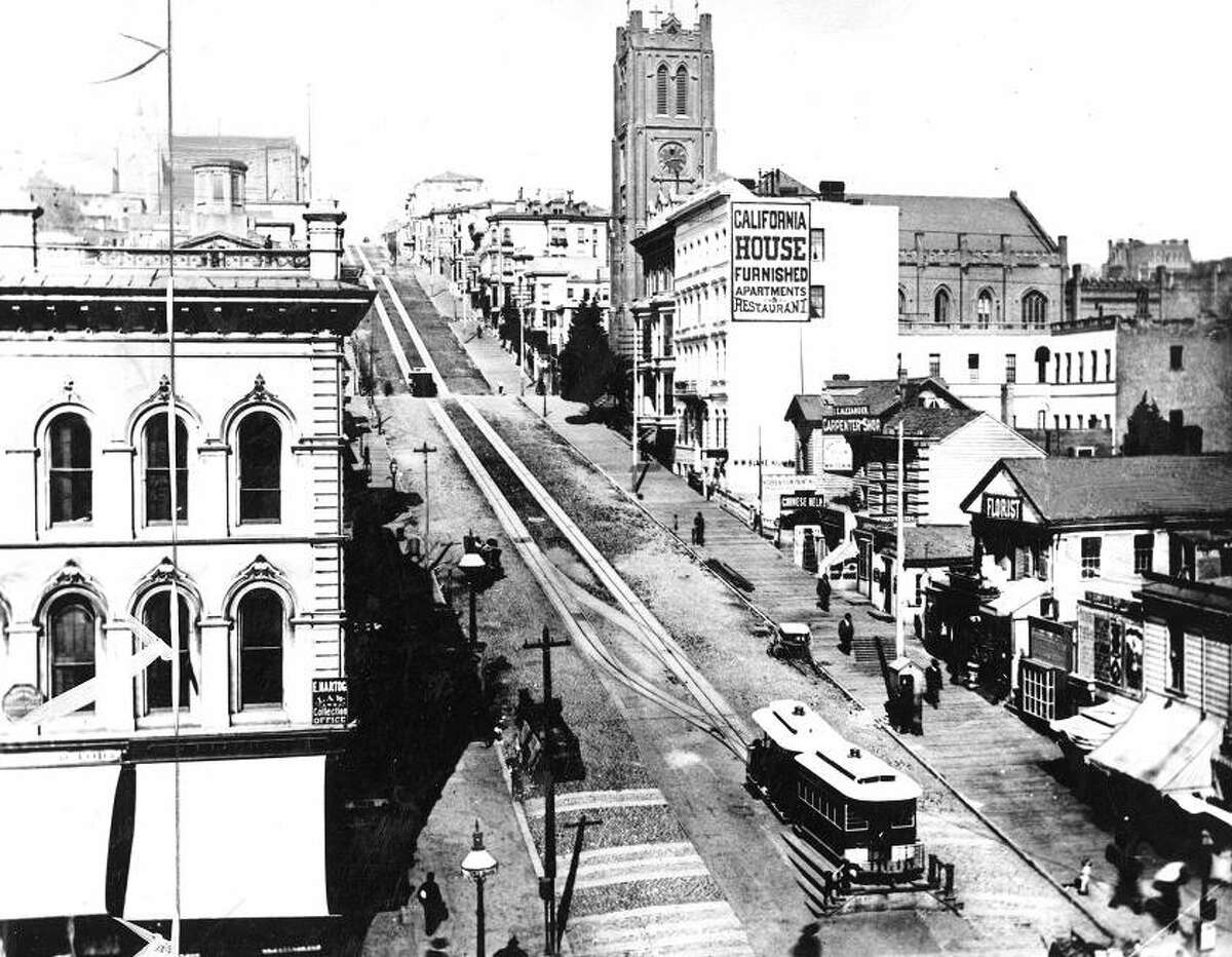 Circa 1880s: The Kearny Street terminus for the California Street cable car. Note the wooden sidewalks. I expected more spittoons.