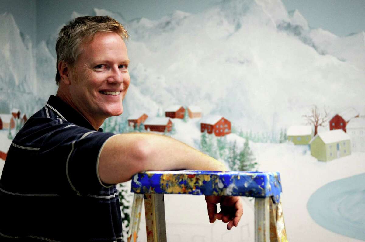Joe Belisle takes a break from painting murals to pose for a photo at Stamford Twin Rinks on Thursday, July 26, 2012.