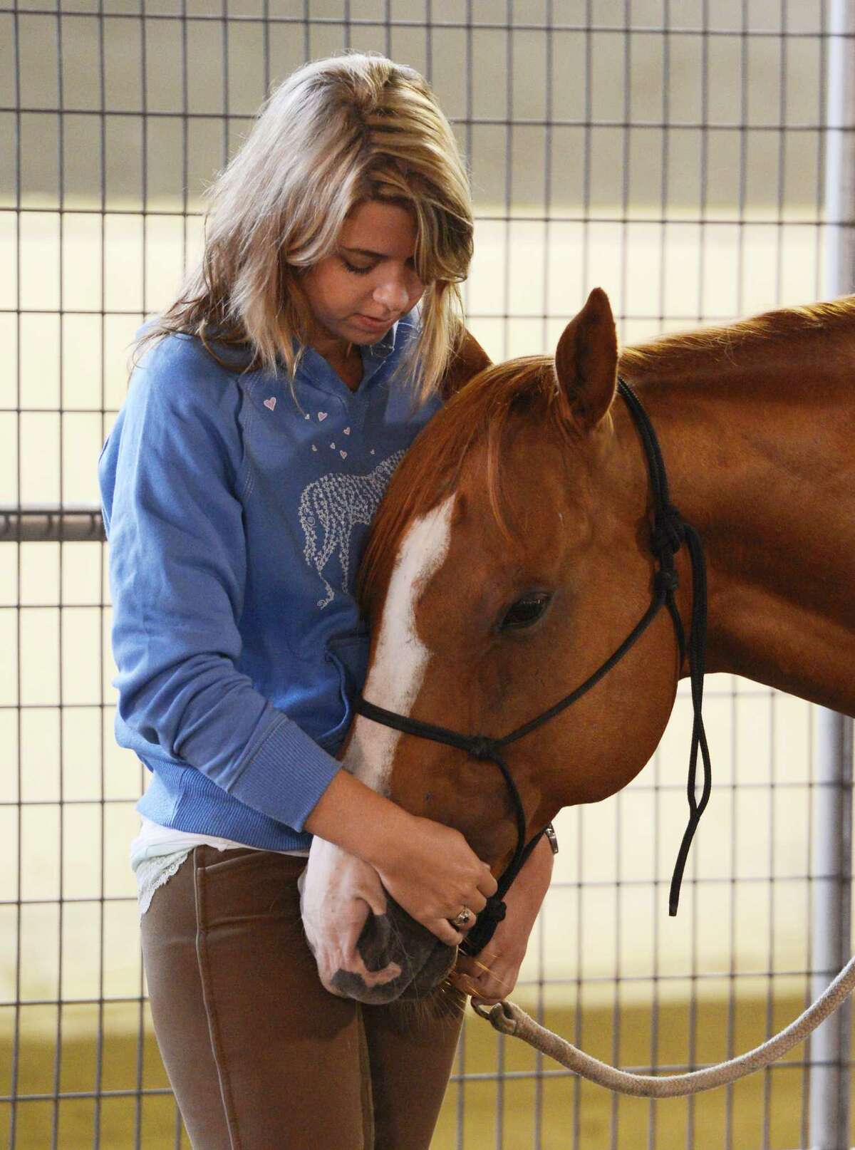 Military suicide widow Rebecca Morrison, has a quiet moment with Butter during her introduction to the Saratoga War Horse Program in Saratoga Springs, N.Y. July 26, 2012 (Skip Dickstein/Times Union)