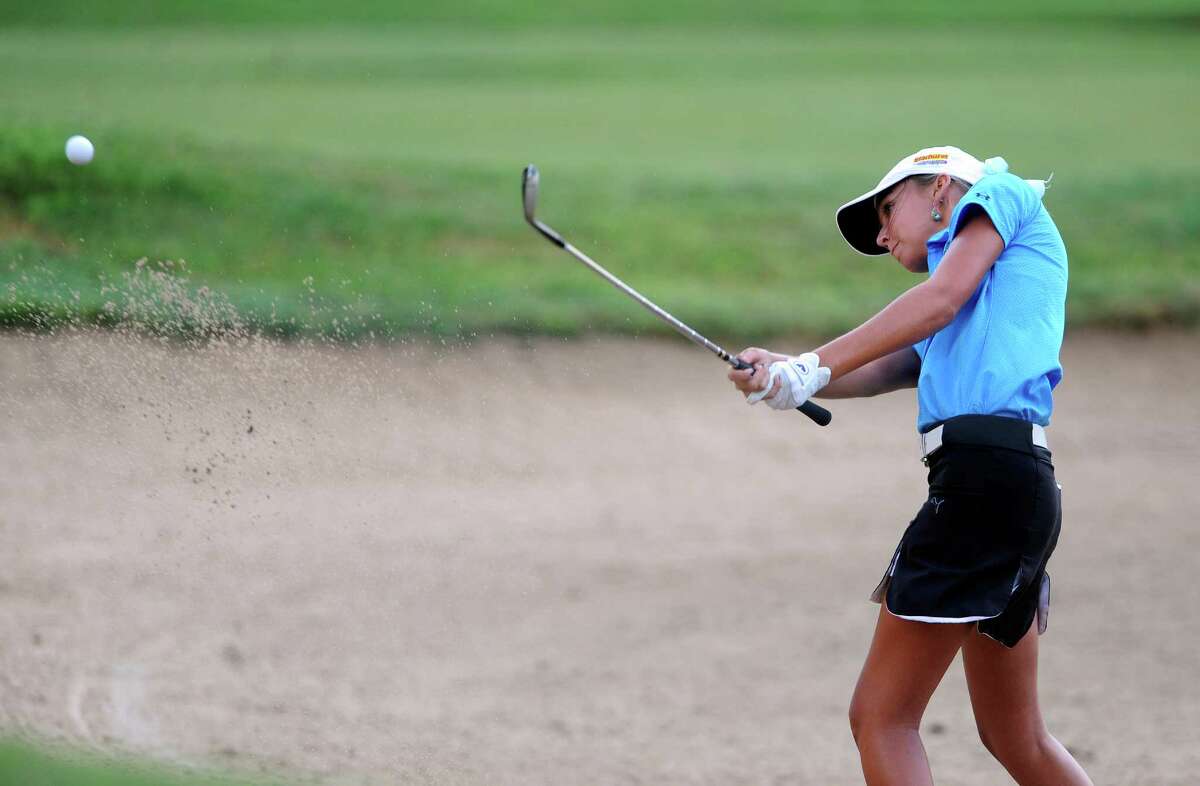 Caitlin Brown hits out of a bunker on the No. 10 hole during first-round action of the Greater San Antonio Junior Championship at Brackenridge Park Golf Course on Tuesday, July 24, 2012.