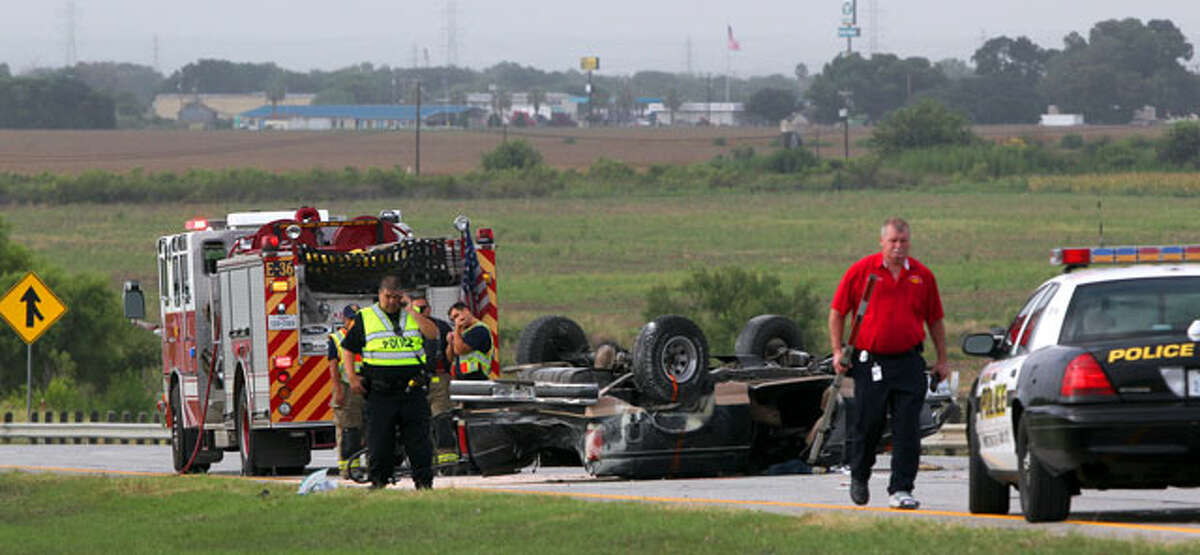 Police and firefighters work at the scene of a rollover accident on Loop 410 and Old Pearsall Road Friday morning July 27, 2012. The driver of the truck is in critical condition and the accident took place about 7:30 a.m. . Southbound lanes on Loop 410 in the area were closed so that investigators could continue probing the scene. John Davenport/San Antonio Express-News