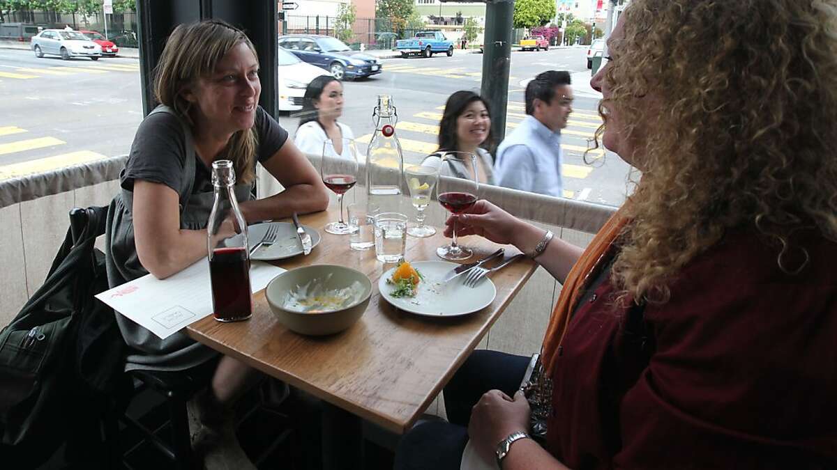 Deirdre Scully and Stephanie Rogerson enjoy and appetizer with wine at a corner table. Dinners at Rich Table restaurant on Gough Street in San Francisco are offered a wide menu of both food and wine. Thursday, July 26, 2012.
