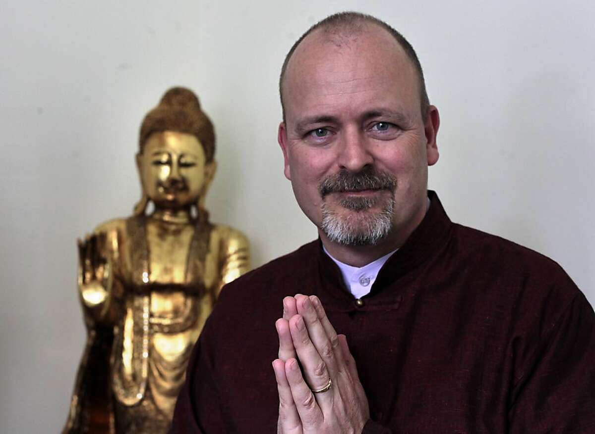Evan Kavanagh, sits in his living room, Sunday July 22, 2012, at his home in San Francisco, Calif. Kavanagh is a Buddhist minister who performs weddings in addition to a full-time job at UCSF where he is a director of development at the Osher Center.