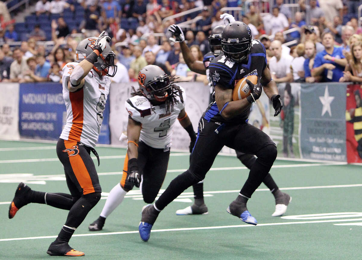 San Antonio Talons' Derek Lee (18) pulls away from Utah Blaze's David Hyland (09) and Alfred Phillips (04) for a touchdown in the first half of their quarterfinal AFL National Conference playoff game at the Alamodome on Friday, July 27, 2012.