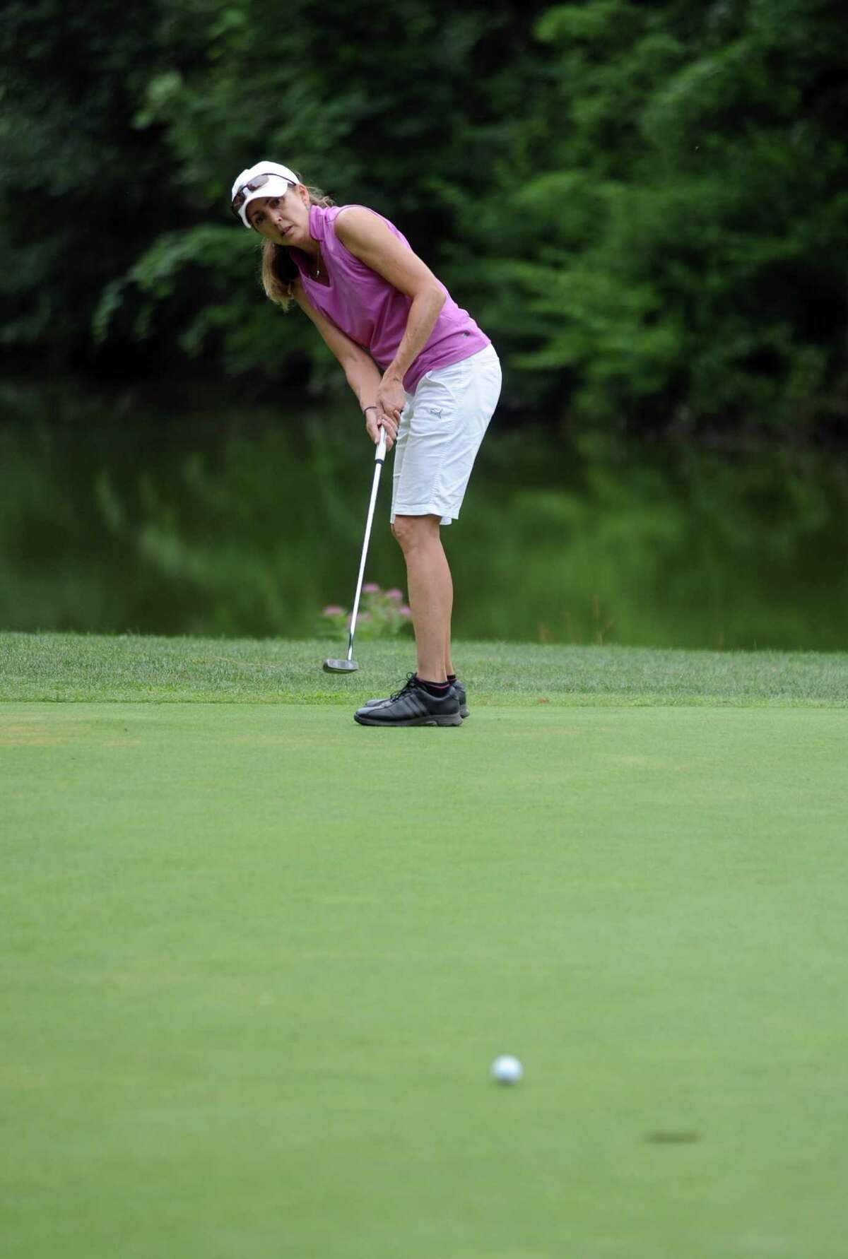 Teresa White makes a long putt as she plays in the 2012 Stamford Amateur Golf Championship at E.G. Brennan golf course on Saturday, July 28, 2012.