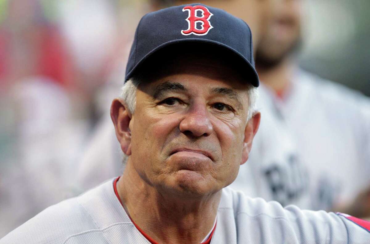 Boston Red Sox manager Bobby Valentine (25) looks out from the dugout during the first inning of a baseball game against the Texas Rangers, Monday, July 23, 2012, in Arlington, Texas. (AP Photo/LM Otero)