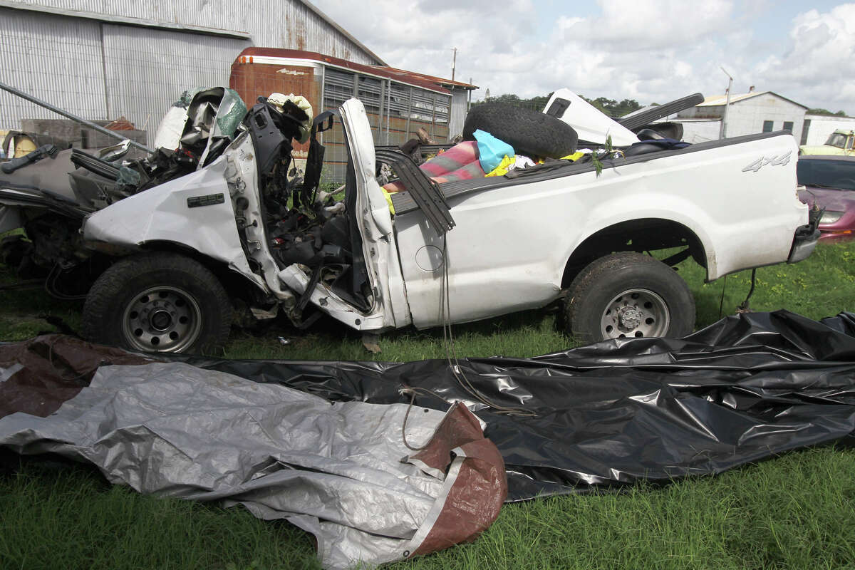 This Monday, July 23, 2012 photo shows what remains of a 2000 Ford F-250 pickup truck after it crashed into a tree on the side of U.S. Highway 59 between Goliad and Beeville, Texas before 7:00 p.m. Sunday evening. The truck, overloaded with nearly two dozen illegal immigrants, veered off a highway and crashed into trees, killing at least 14, authorities said. (AP Photo/San Antonio Express-News, John Davenport) RUMBO DE SAN ANTONIO OUT; NO SALES