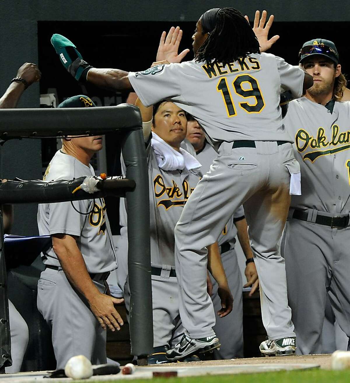 Oakland A's Yoenis Cespedes (R) gets a high five from Josh