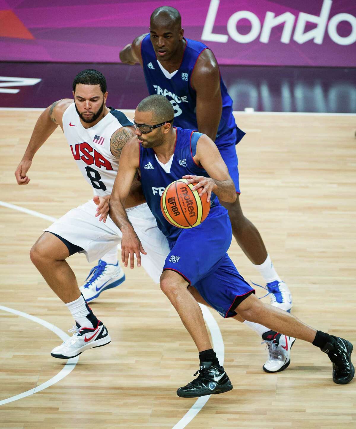France's Tony Parker drives around USA's Deron Williams during men's preliminary round basketball at the 2012 London Olympics on Sunday, July 29, 2012.