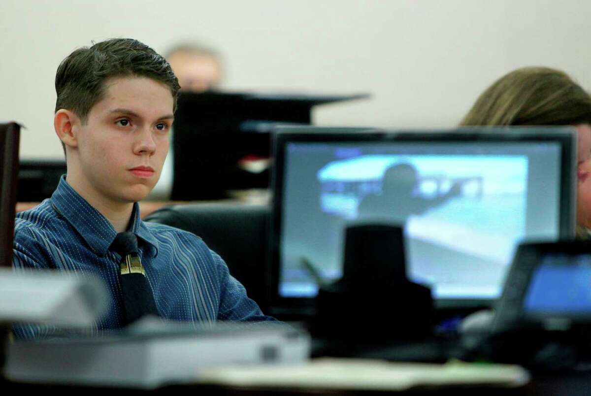 Alexander Samuel Olivieri, 19, looks at a video of himself at a shooting range shown by the prosecutor during his murder trial in Jim Wallace's State District Court at the Harris County Criminal Courthouse on Monday, July 30, 2012, in Houston. Olivieri is charged with killing teenager Bridgett Frisbie by shooting her once in the back of the head execution-style in the early morning hours of April 3, 2011 because she knew about an alleged drive-by shooting. ( Mayra Beltran / Houston Chronicle )