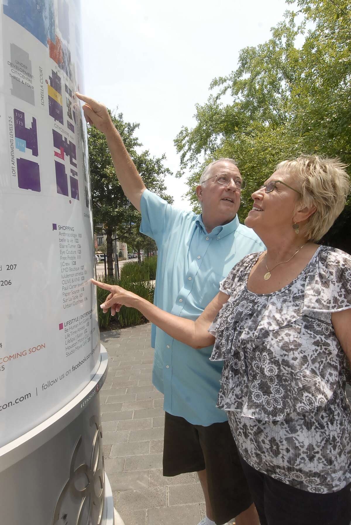 Roger Keyte and Carol Keyte pinpoint the location of Sur La Table on a map at the CityCentre complex.