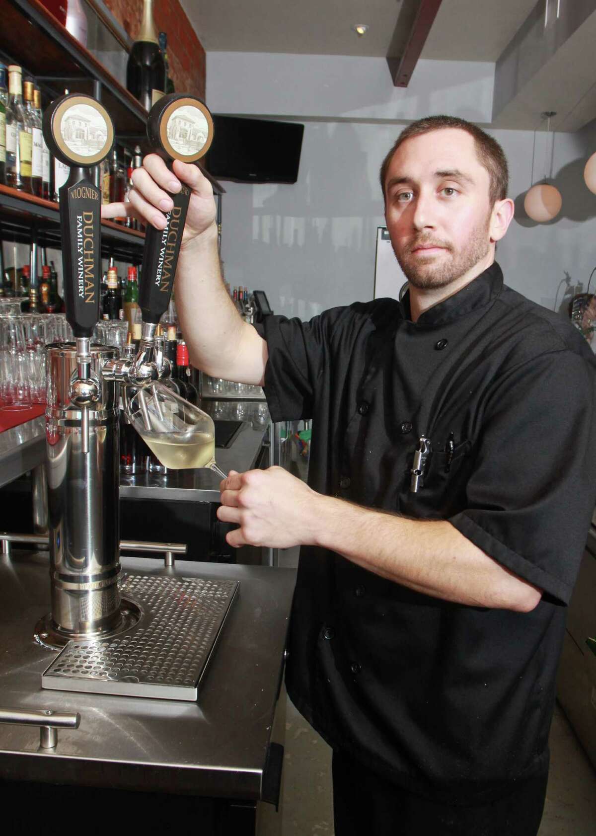 (For the ChronicleGary Fountain, July 24, 2012) Stefan Breitweiser using a tap for a glass of Duchman Bermantino wine at L'Olivier Restaurant & Bar.