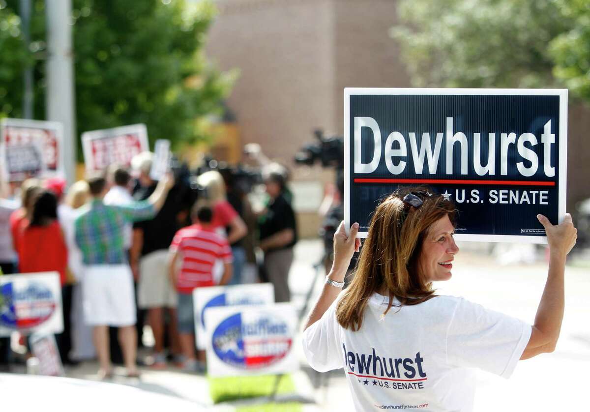 A Dewhurst supporter stands alone as supporters for Ted Cruz, Republican candidate for U.S. Senate, wait for his visit at St. Martin's Episcopal Church on Tuesday, July 31, 2012, in Houston.