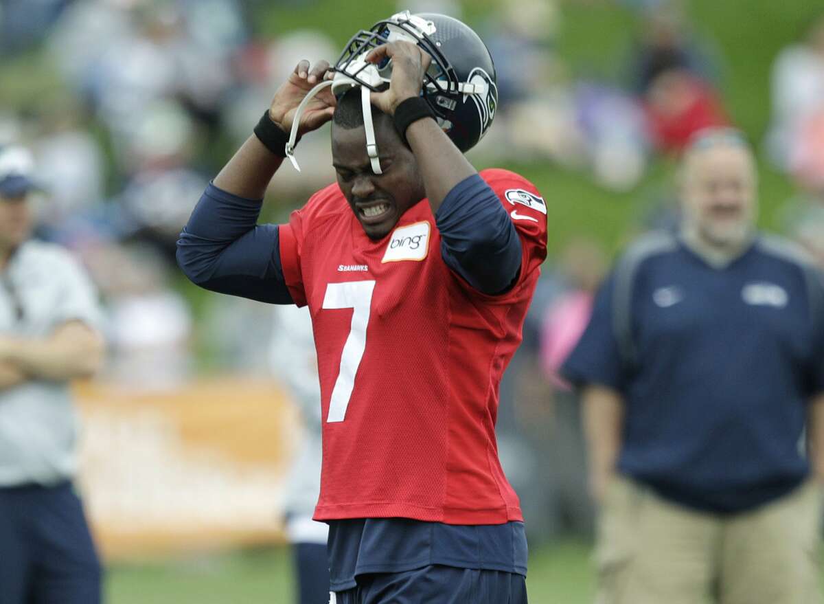 Seattle Seahawks quarterback Tavaris Jackson takes off his helmet during a break in practice drills, Monday, July 30, 2012, at NFL football training camp in Renton, Wash. (AP Photo/Ted S. Warren) (AP)