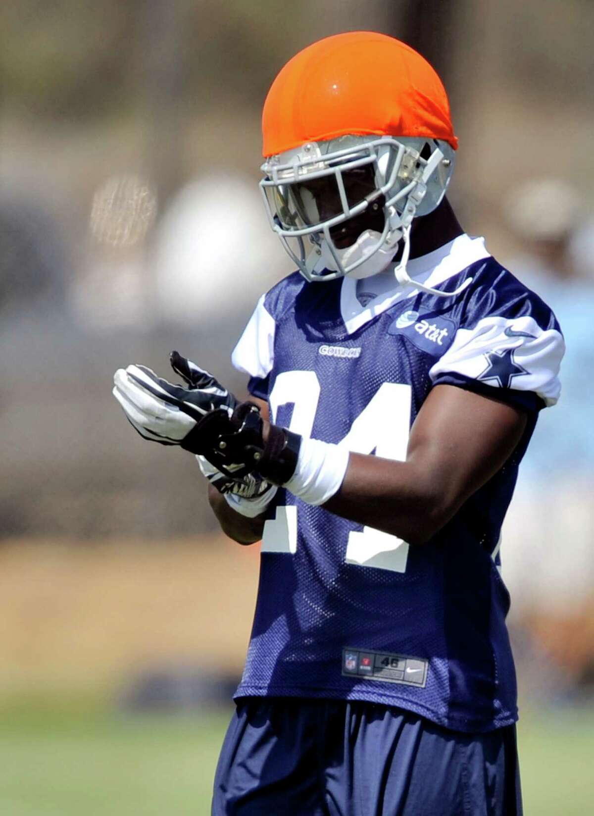 Dallas Cowboys cornerback Morris Claiborne checks his wristband before participating in a drill during NFL training camp, Tuesday, July 31, 2012, in Oxnard, Calif. (AP Photo/Gus Ruelas)