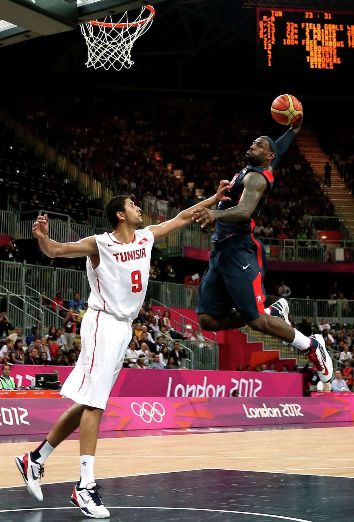 LONDON, ENGLAND - JULY 31: Lebron James #6 of United States dunks the ball over Mohamed Hadidane #9 of Tunisia during the Men's Basketball Preliminary Round match on Day 4 of the London 2012 Olympic Games at Basketball Arena on July 31, 2012 in London, England. (Photo by Ezra Shaw/Getty Images) ***BESTPIX***