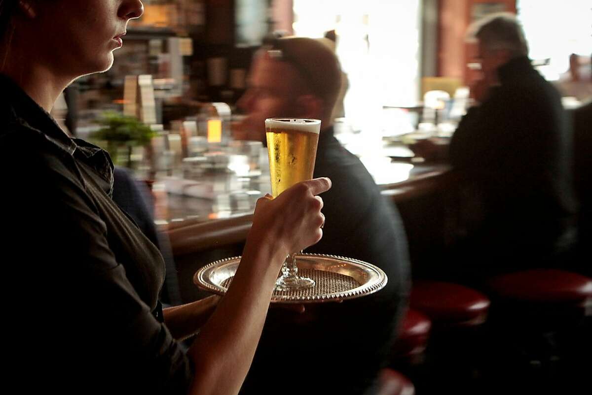 A server takes a beer to a table at Revival Bar & Restaurant in Berkeley, Calif., on Wednesday, July 25th, 2012.