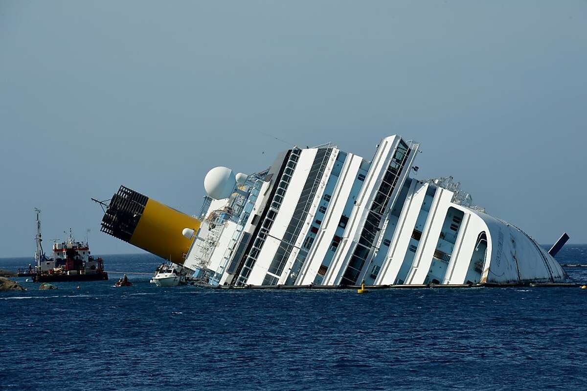 (FILES) This recent file picture taken on June 25, 2012 shows workers of the US firm Titan Salvage and Italian firm Micoperi working on the stranded Costa Concordia cruise ship near the harbour of Giglio Porto. A newspaper in Italy reported citing investigators on July 3, 2012 that the Italian cruise ship which crashed in January killing 32 people was sailing with its sealed doors open, unapproved maps and faulty instruments. AFP PHOTO/ FILES/VINCENZO PINTOVINCENZO PINTO/AFP/GettyImages