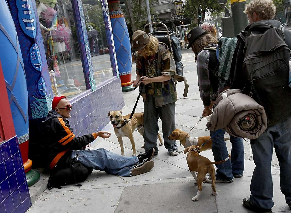 A group of "street kids" stop to talk with a panhandler on Haight Street near Masonic Avenue. San Francisco's controversial sit lie law, which makes it against the law to sit or lie on a city sidewalk, is being enforced exclusively in the Haight Ashbury neighborhood.