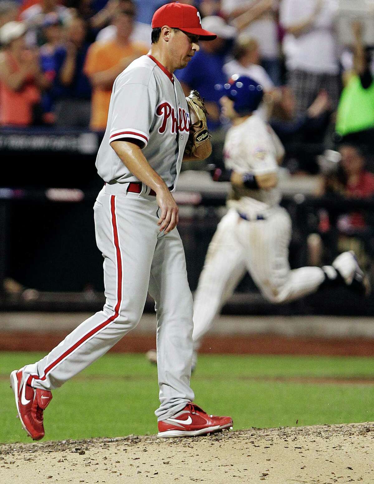 Philadelphia Phillies relief pitcher Brian Sanches reacts as New York Mets' David Wright head to home plate after hitting a three-run home run during the sixth inning of a baseball game, Tuesday, July 3, 2012, in New York. (AP Photo/Frank Franklin II)