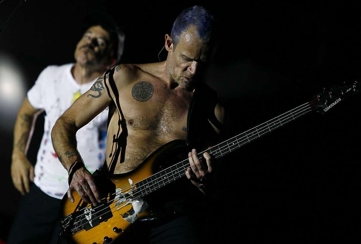 Red Hot Chili Peppers' Mike "Flea" Balazary, right, and Anthony Kiedis, left, perform during the Rock in Rio music festival in Arganda del Rey, on the outskirts of Madrid, Spain, Sunday, July 8, 2012. (AP Photo/Andres Kudacki)